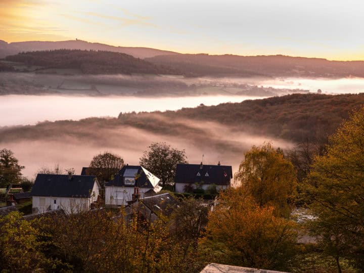 Autumn landscape in Burgundy at Château-Chinon in France, with forests, hills, and houses at sunrise
