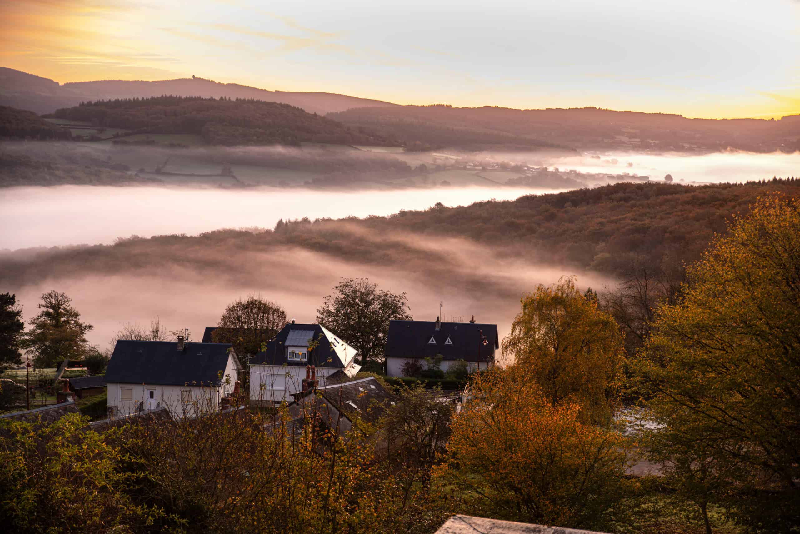 Autumn landscape in Burgundy at Château-Chinon in France, with forests, hills, and houses at sunrise