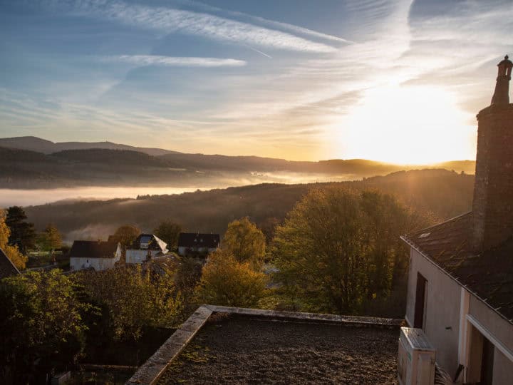 Autumn landscape in Burgundy at Château-Chinon in France, with forests, hills, and houses at sunrise